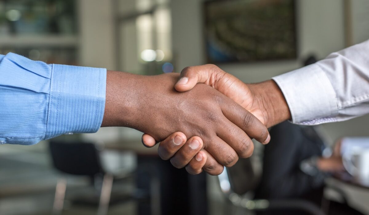 Interview handshake representing green card USCIS interview preparation 2026