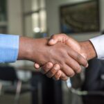 Interview handshake representing green card USCIS interview preparation 2026