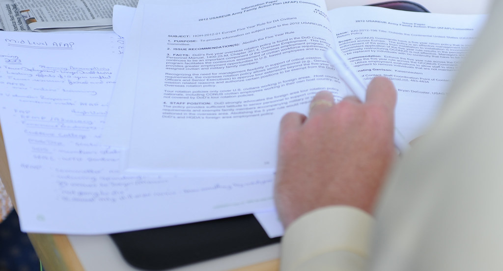 A USCIS officer reviewing an application file during active review