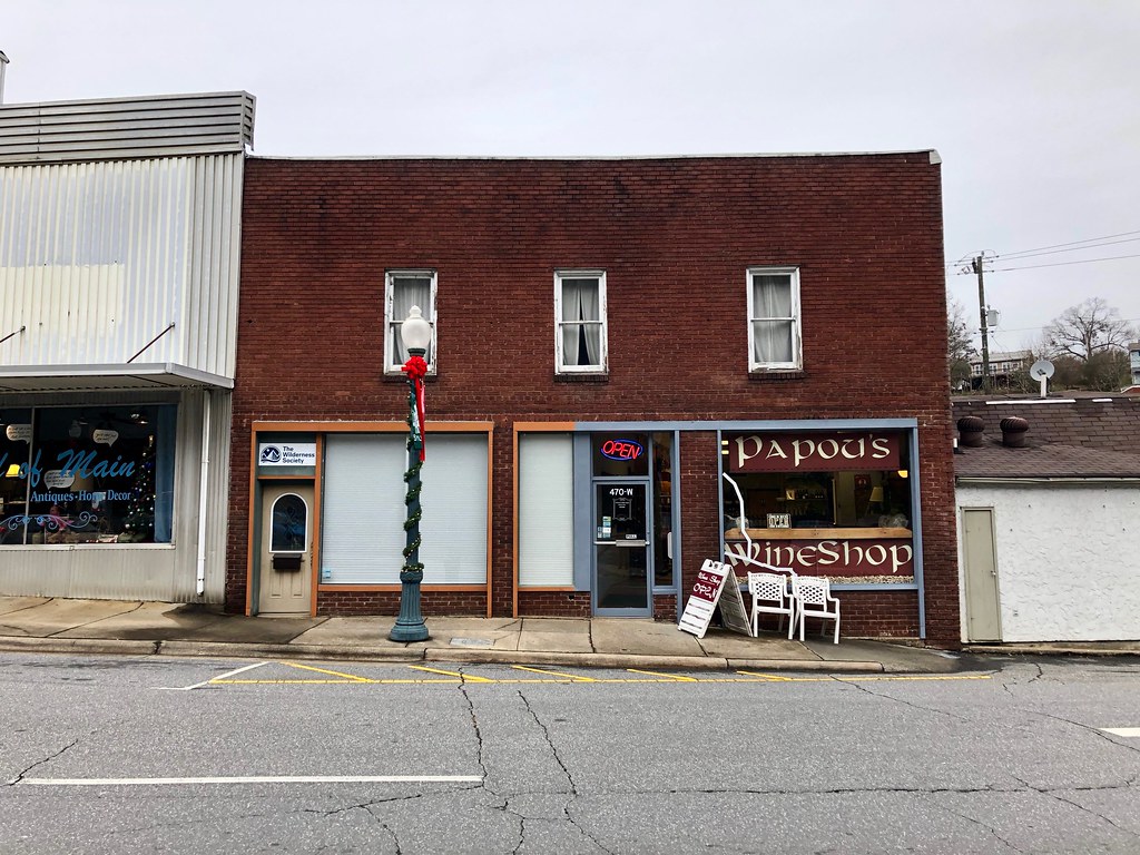 Small business owner standing in the doorway of a retail shop