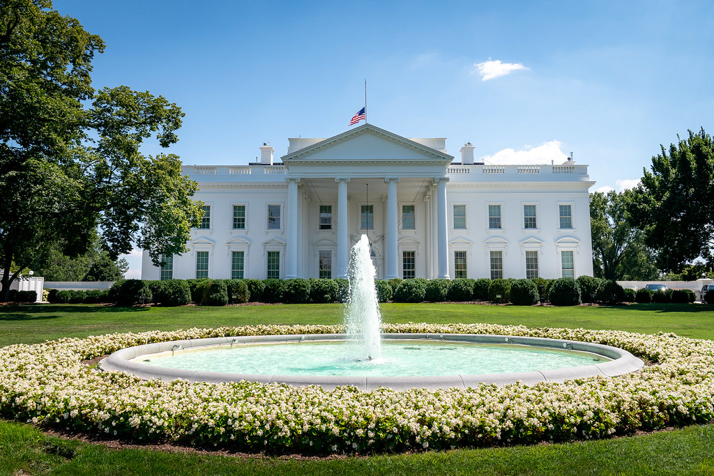 United States flag representing federal employer sponsorship programs like H-1B and PERM