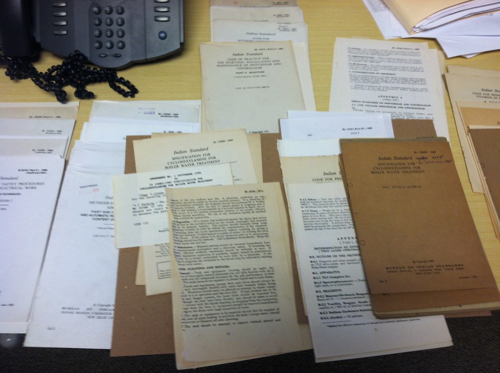 Stack of documents representing I-9 forms reviewed during an ICE compliance audit